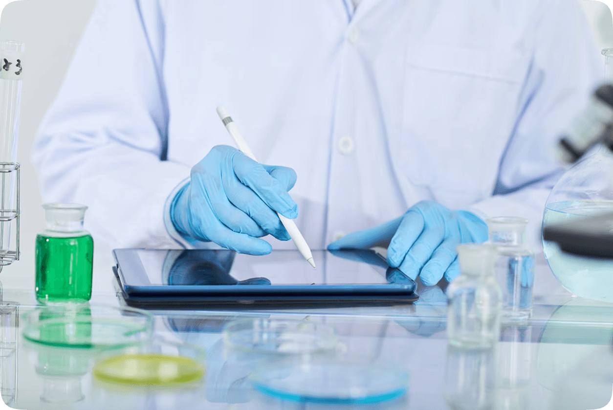 Scientist with gloves writing on an electronic tablet notebook