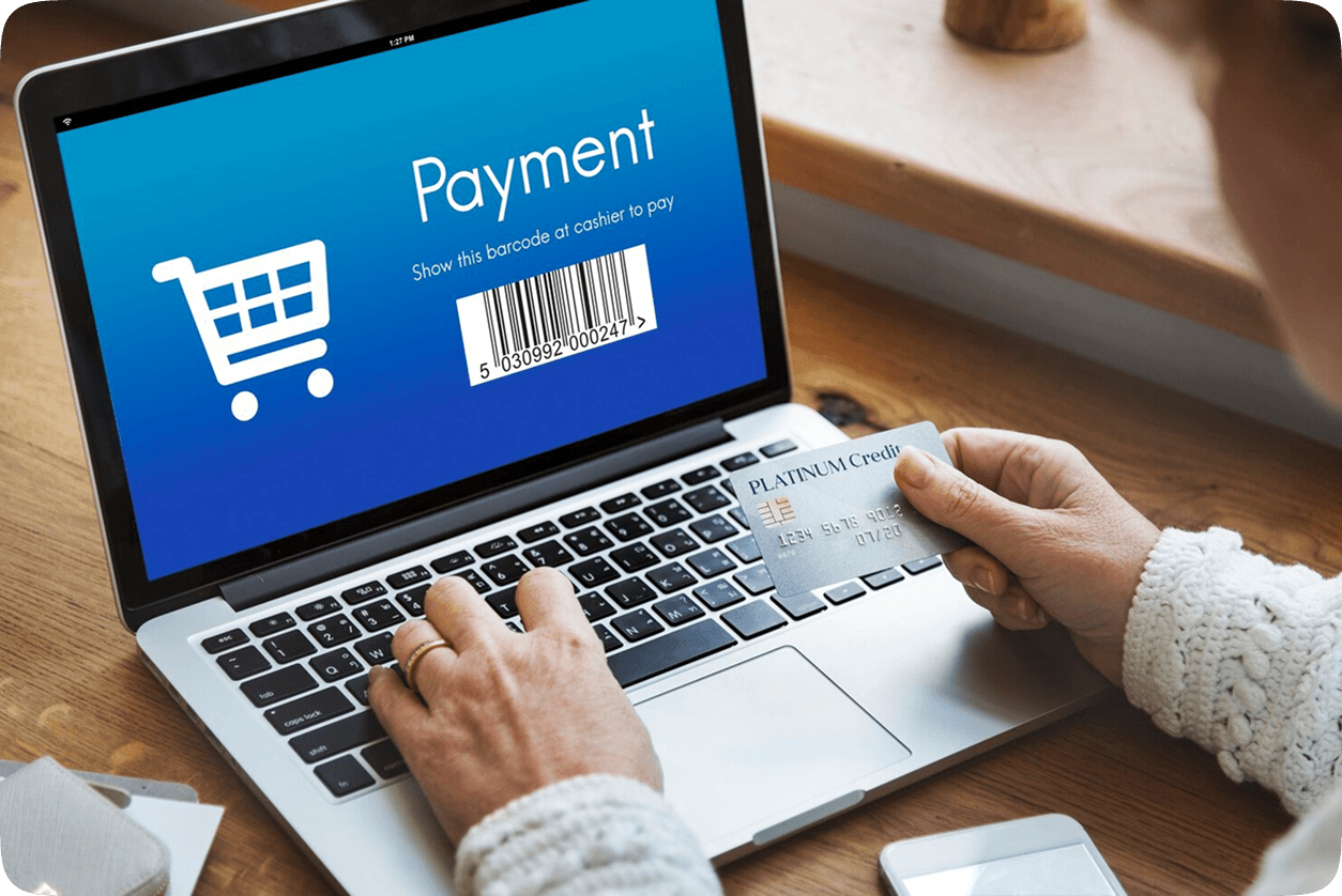 Woman looking at a payment UI on a laptop