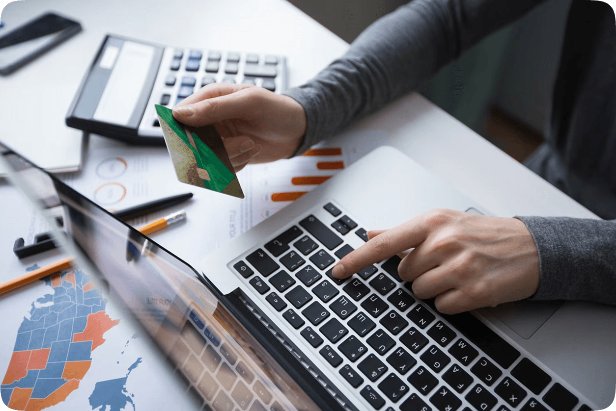 Person making online payment on laptop with credit card